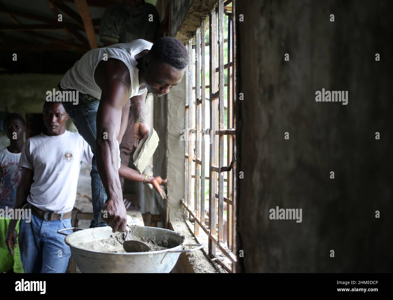 School children and young adults learn trades at an NGO funded vocational and technical school in Sierra Leone. Stock Photo