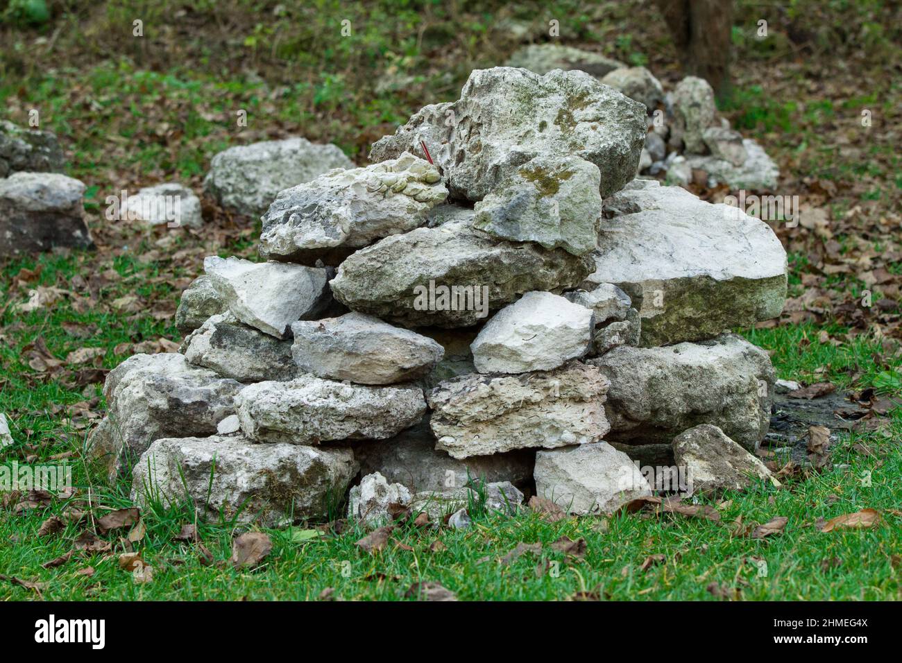 Stack of random grey stones on the grass Stock Photo - Alamy