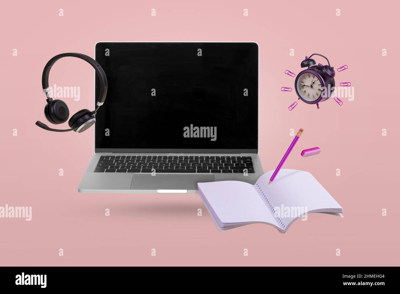 Creative idea made with a laptop, headphones, school supplies and alarm clock  flying in the air. Back to school. Online teaching. Minimal, conceptual Stock Photo