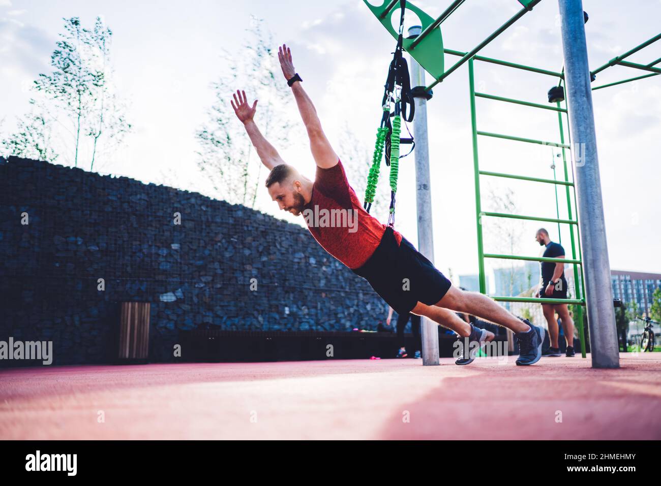 Strong sportsman exercising on sports ground Stock Photo