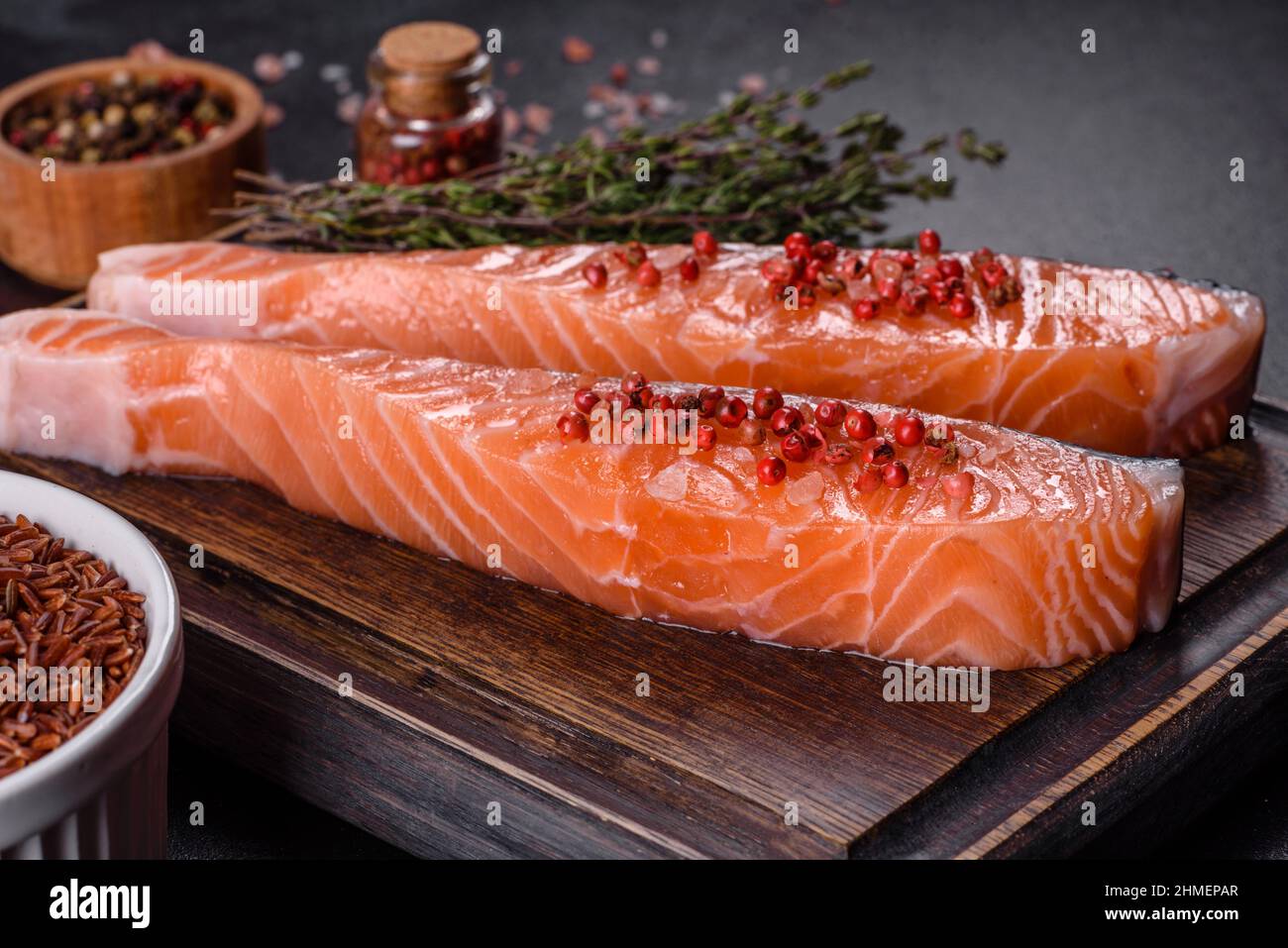 Salmon. Fresh raw salmon fish fillet with cooking ingredients and herbs on black background