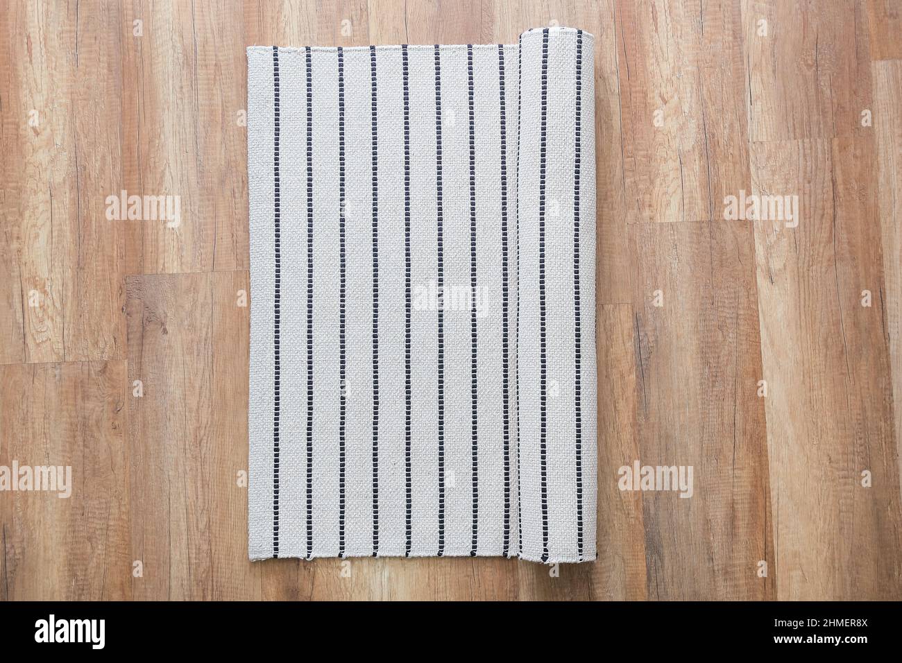 Stylish striped carpet on wooden floor Stock Photo Alamy