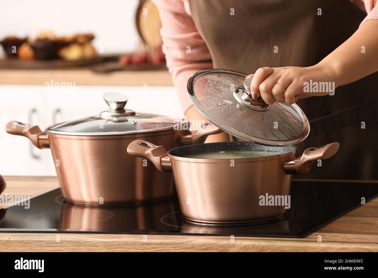 Woman cooking in copper pots at home, closeup Stock Photo Alamy