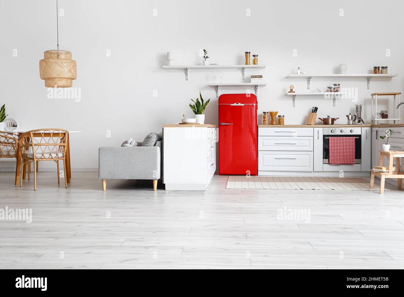Interior of light kitchen with white counters and red fridge Stock ...