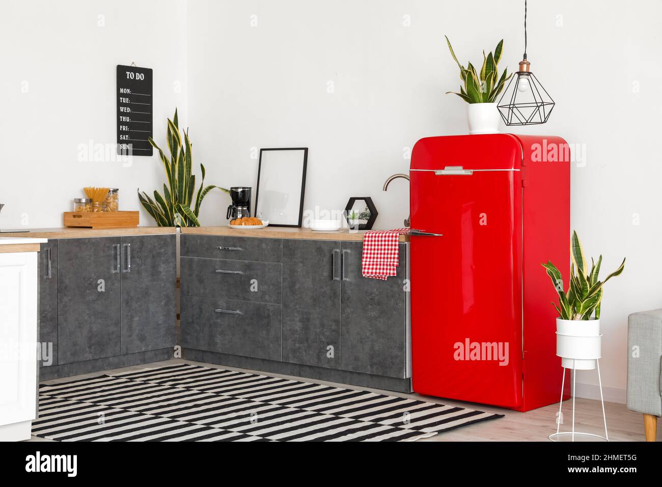 Interior of modern kitchen with counters and red fridge Stock Photo - Alamy