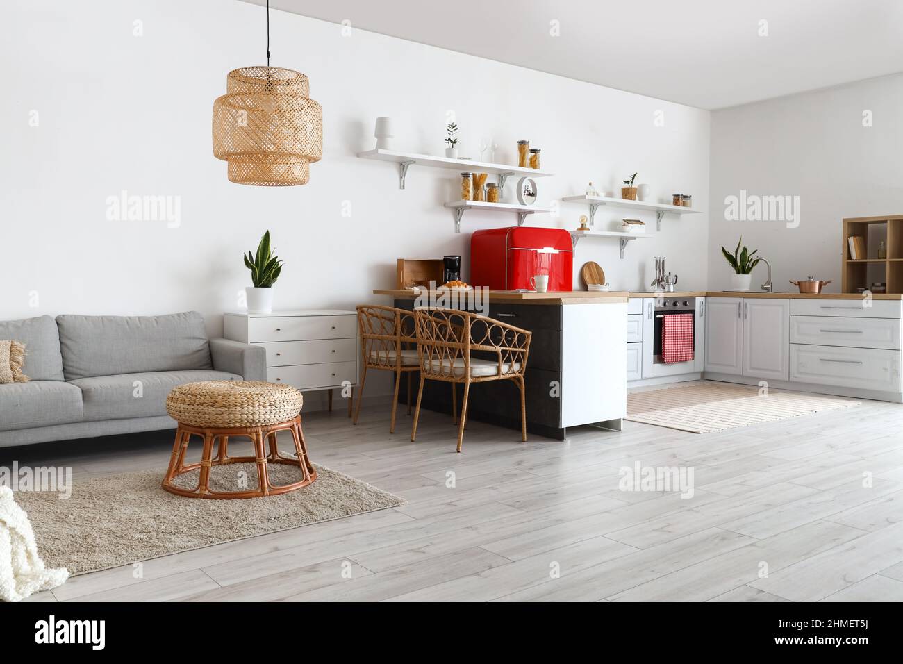Interior of light kitchen with white counters and sofa Stock Photo - Alamy