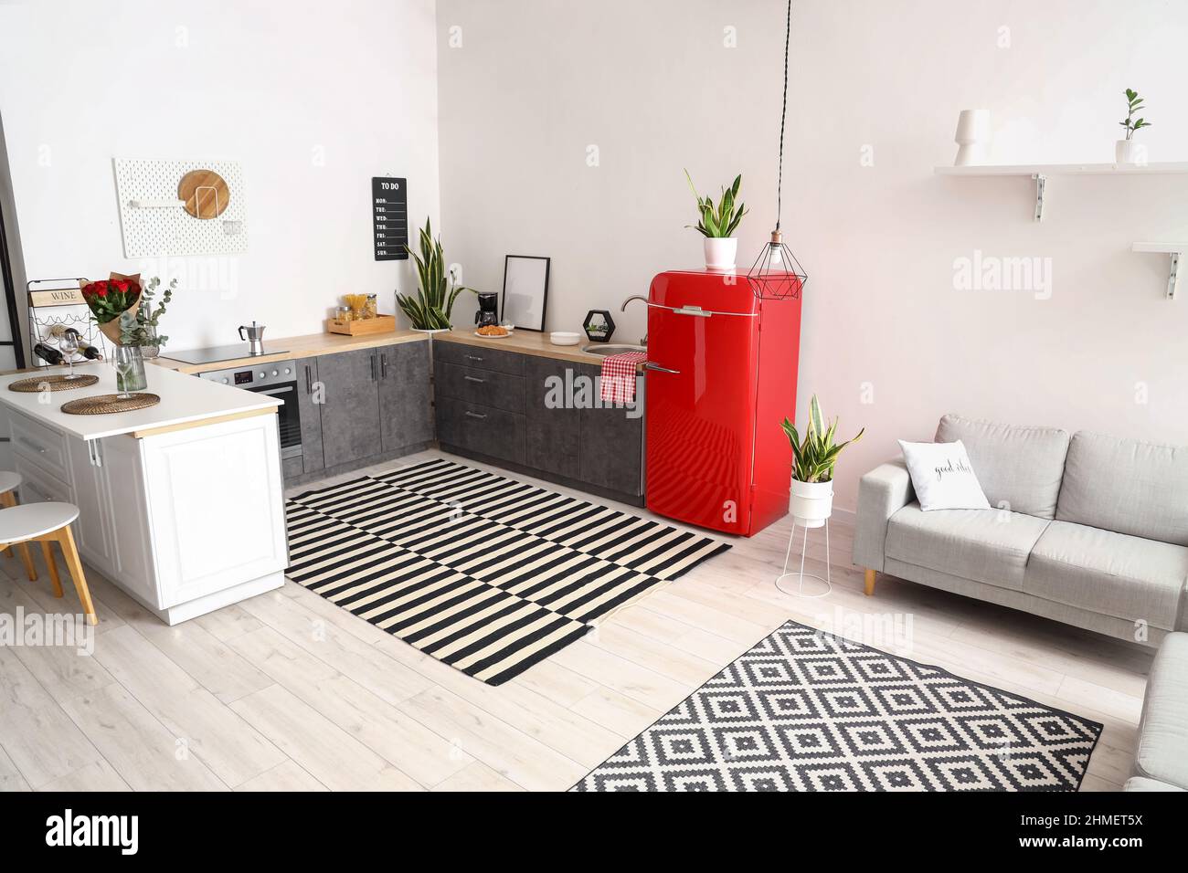 Interior of modern kitchen with counters, sofa and red fridge Stock ...