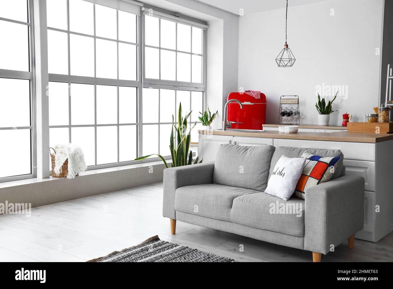 Interior of modern kitchen with red fridge, counters and sofa Stock ...