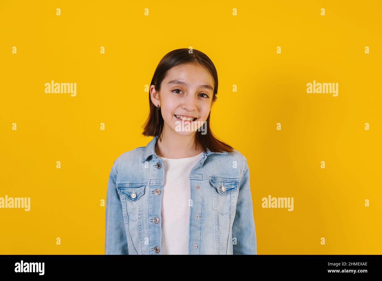 Portrait of latin child girl on yellow background in Mexico Latin America Stock Photo