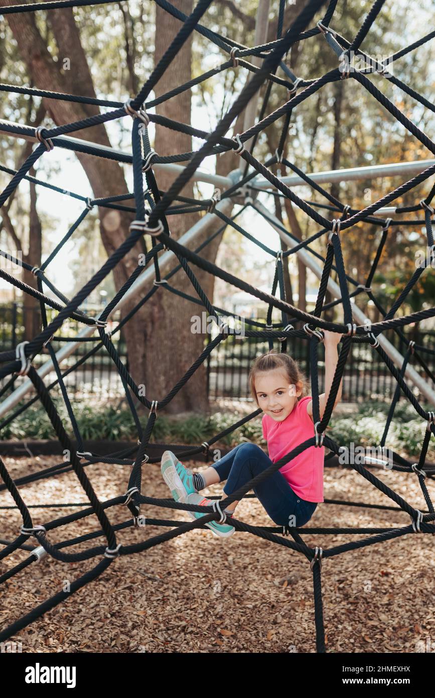 Child at playground. Little girl on a playground climbing net tower.  Outdoor play space on Polyester Twisted Rope. Playground Climbing Rope  Tower Stock Photo - Alamy