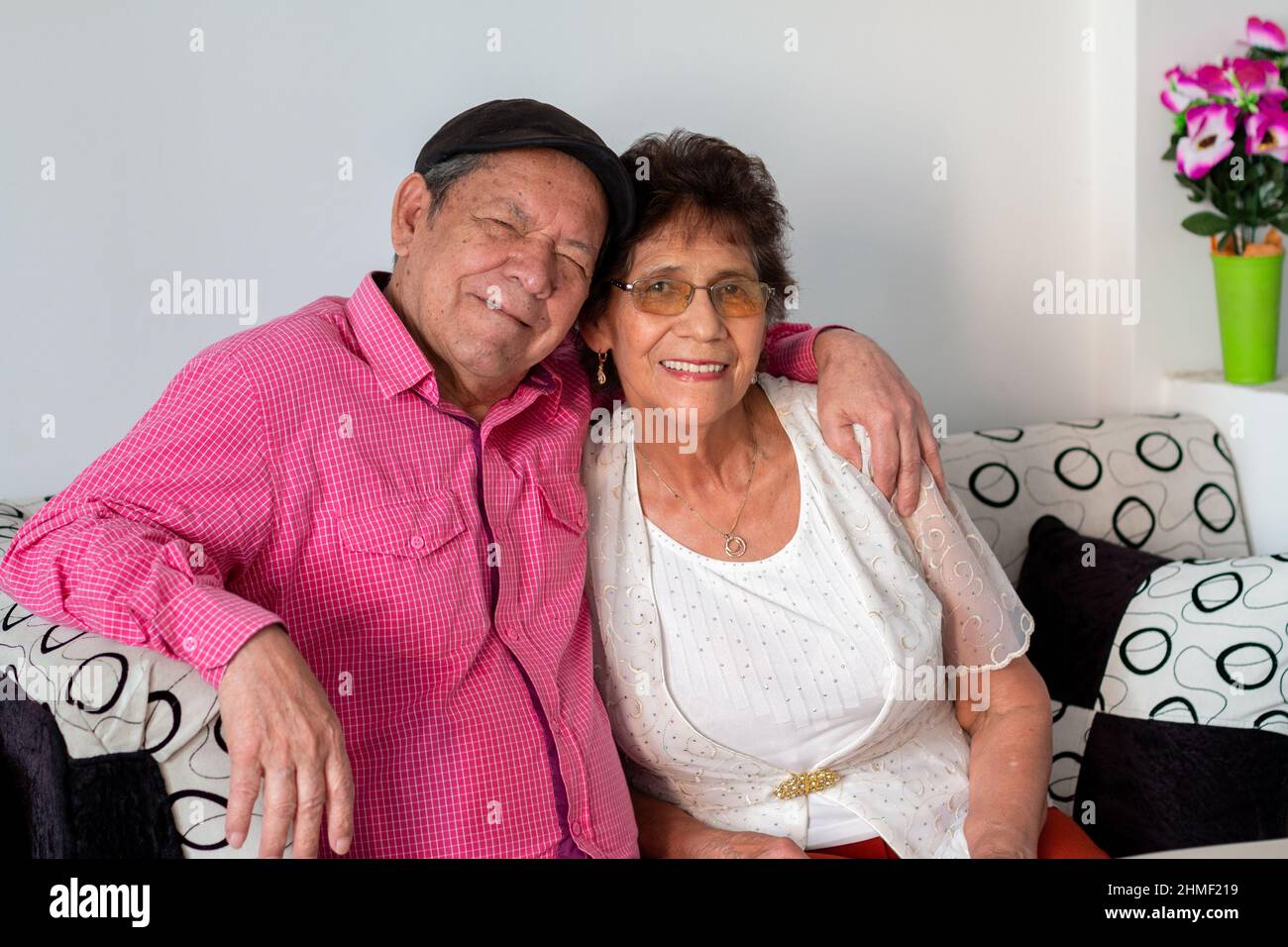 Couple of happy grandparents hugging each other enjoying their retirement. Couple of latin grandparents. Stock Photo