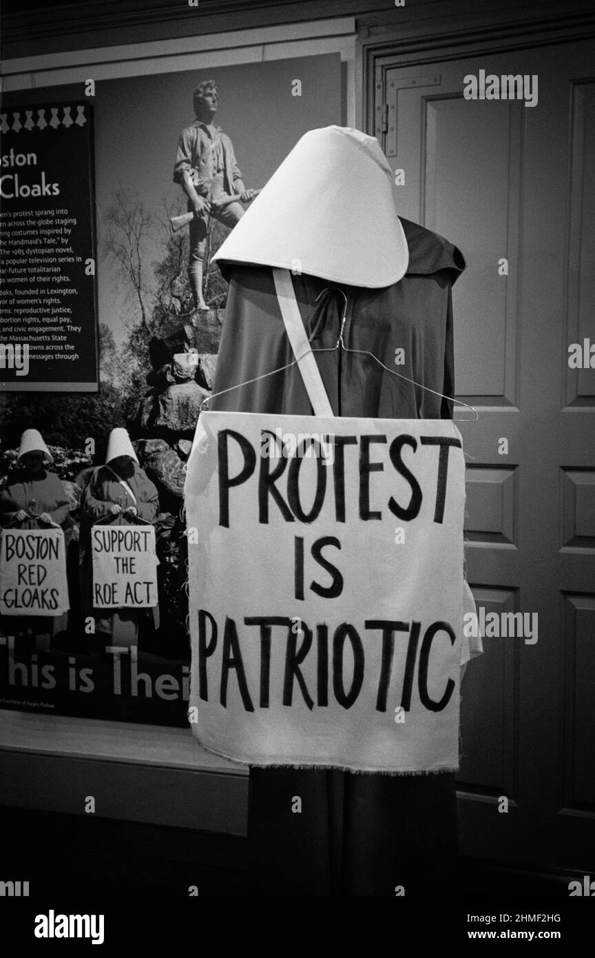 A mannequin is dressed in period clothing wearing a sign that reads Protest is Patriotic in a exhibit at the Lexington Visitors Center. Lexington, Mas Stock Photo
