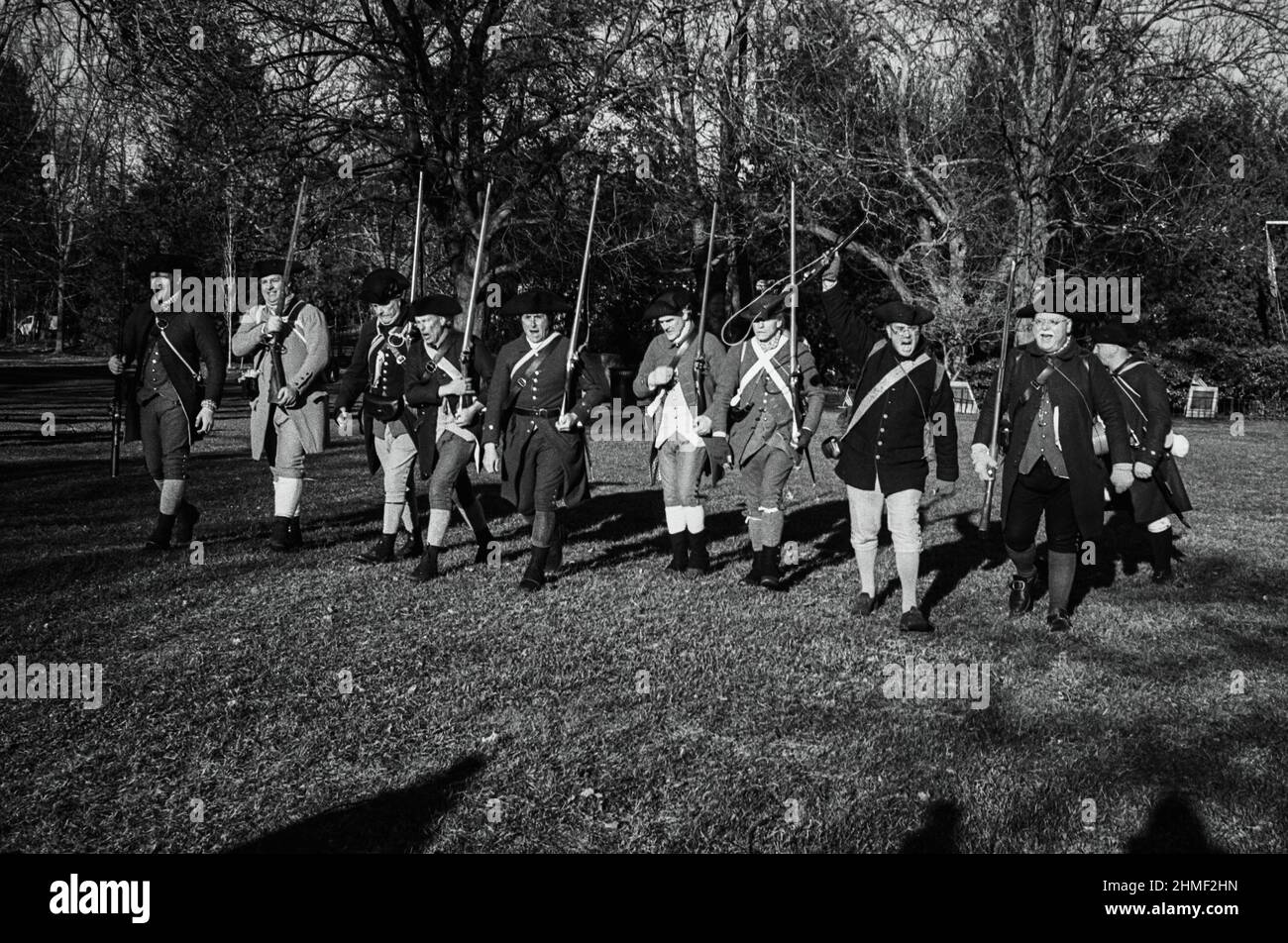 Reenactment characters dressed as Minutemen lead charge on an autumn day at the Tea Burning Ceremony. Lexington, Massachusetts Stock Photo