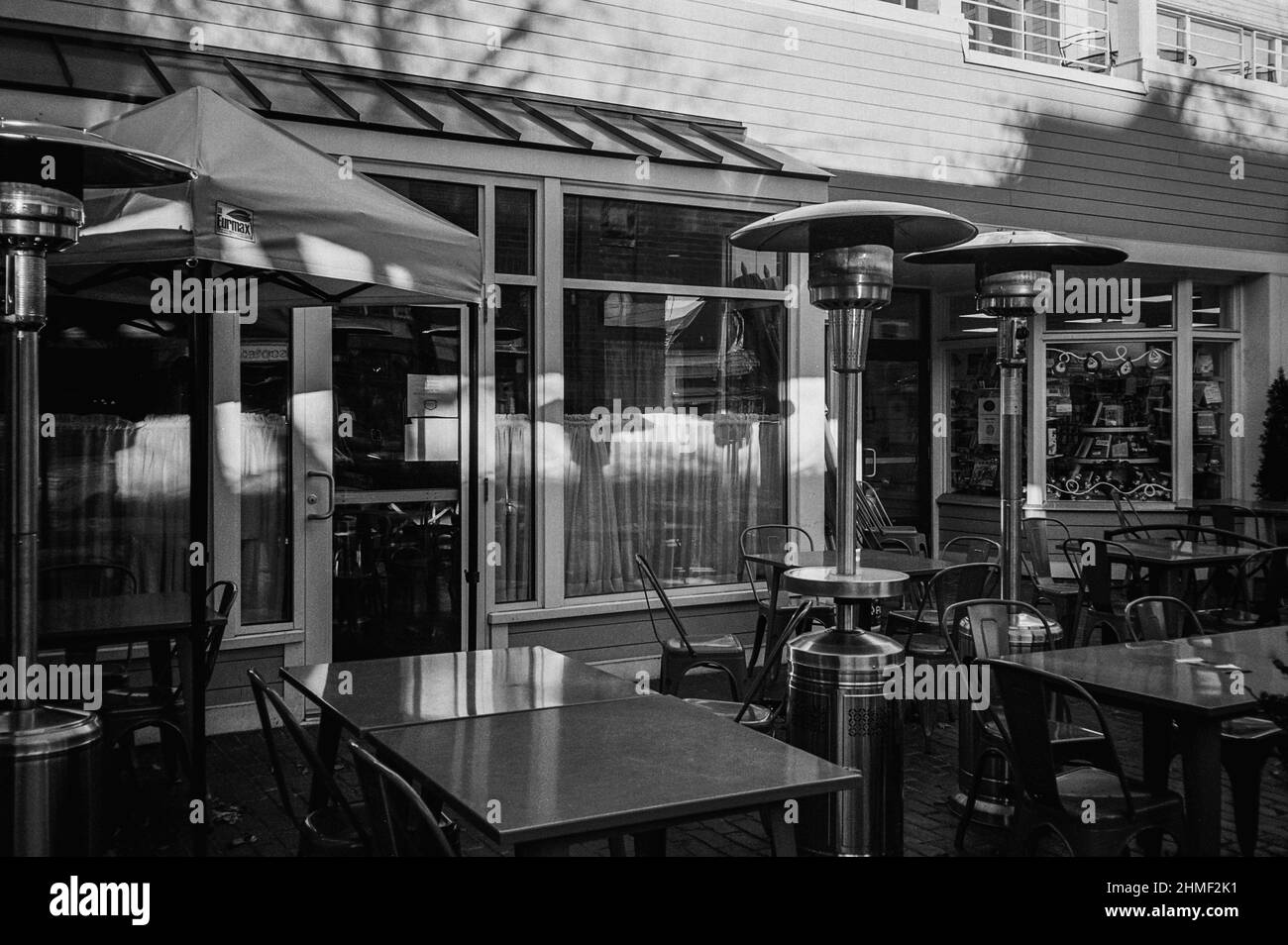 An outdoor seating area for restaurant sits empty during off season on autumn day. Lexington, Massachusetts Stock Photo