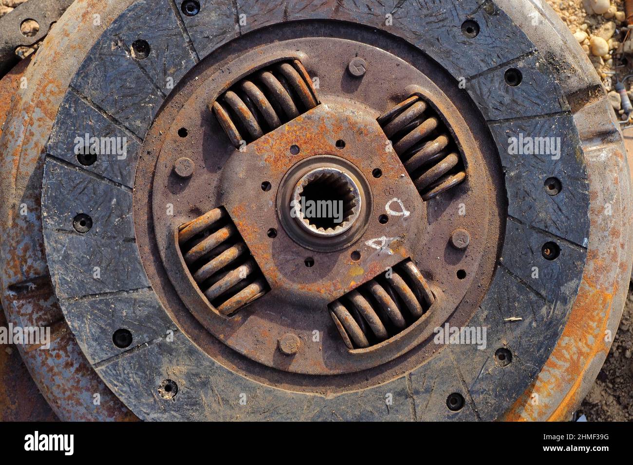 Inner metal disc from pane in scrap yard, graphic pattern of metal ...