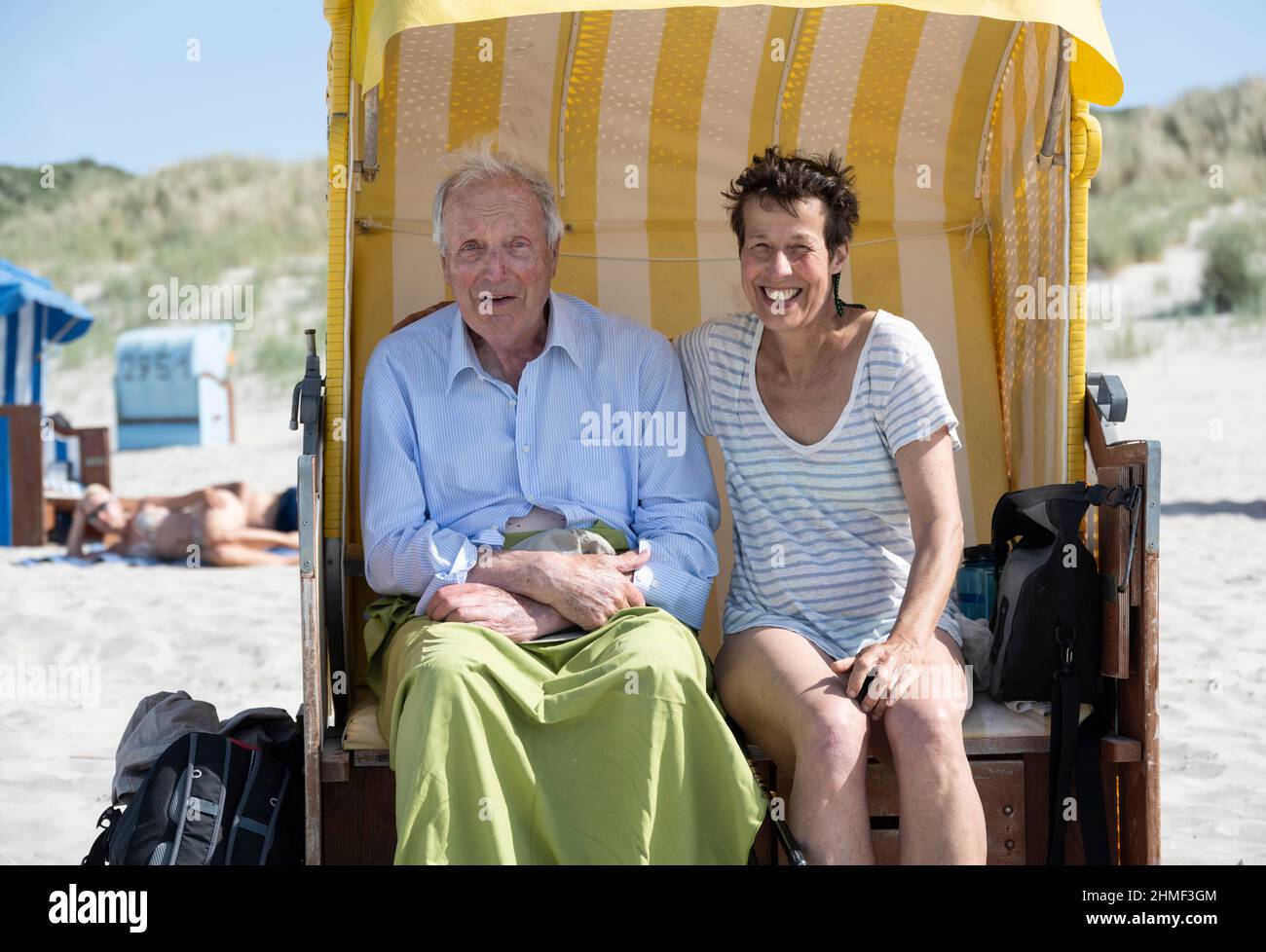 Tourists sitting in a beach chair, Juist Island, North Sea, East Frisia, Lower Saxony, Germany Stock Photo