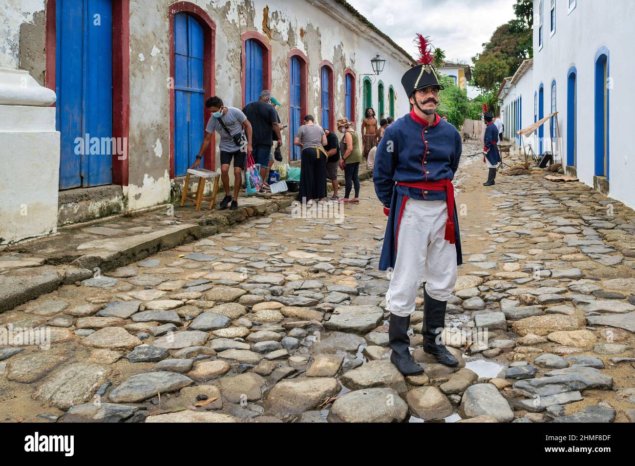 The filming of a TV show or movie set in colonial times in Brazil. There are some actors dressed as soldiers and others as slaves. The scene happens i Stock Photo