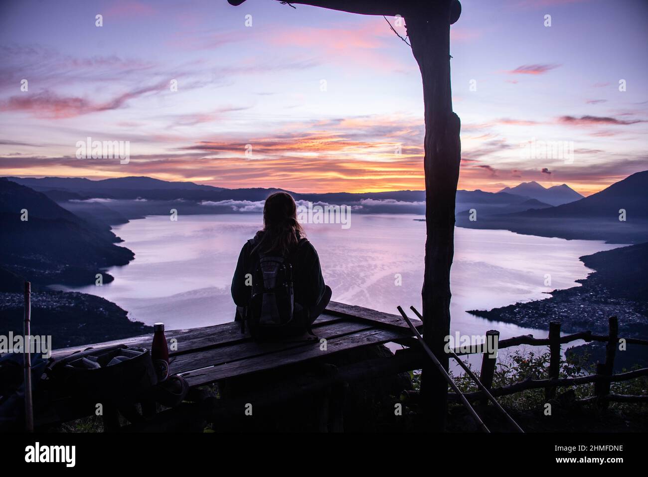 Tourist enjoying the sunrise from La Rostra Maya, Lake Atitlan, Guatemala Stock Photo