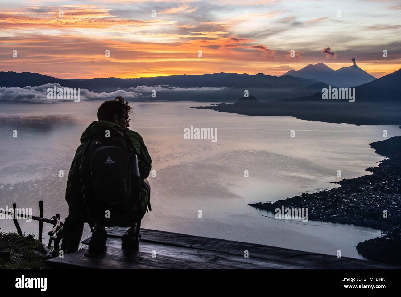 Tourist enjoying the sunrise from La Rostra Maya, Lake Atitlan, Guatemala Stock Photo