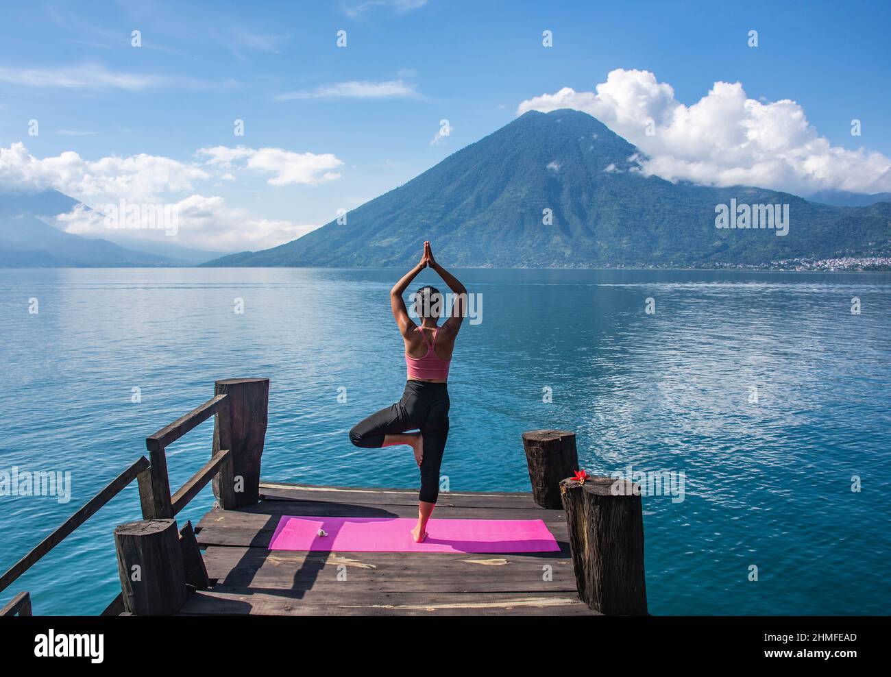 Morning yoga on the dock, San Marcos, Lake Atitlan, Guatemala. Stock Photo