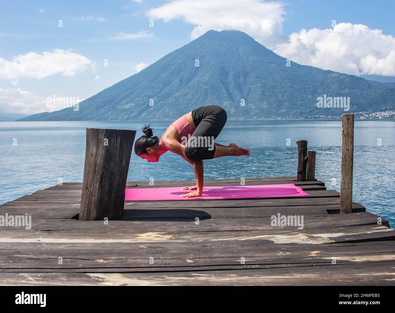 Morning yoga on the dock, San Marcos, Lake Atitlan, Guatemala. Stock Photo