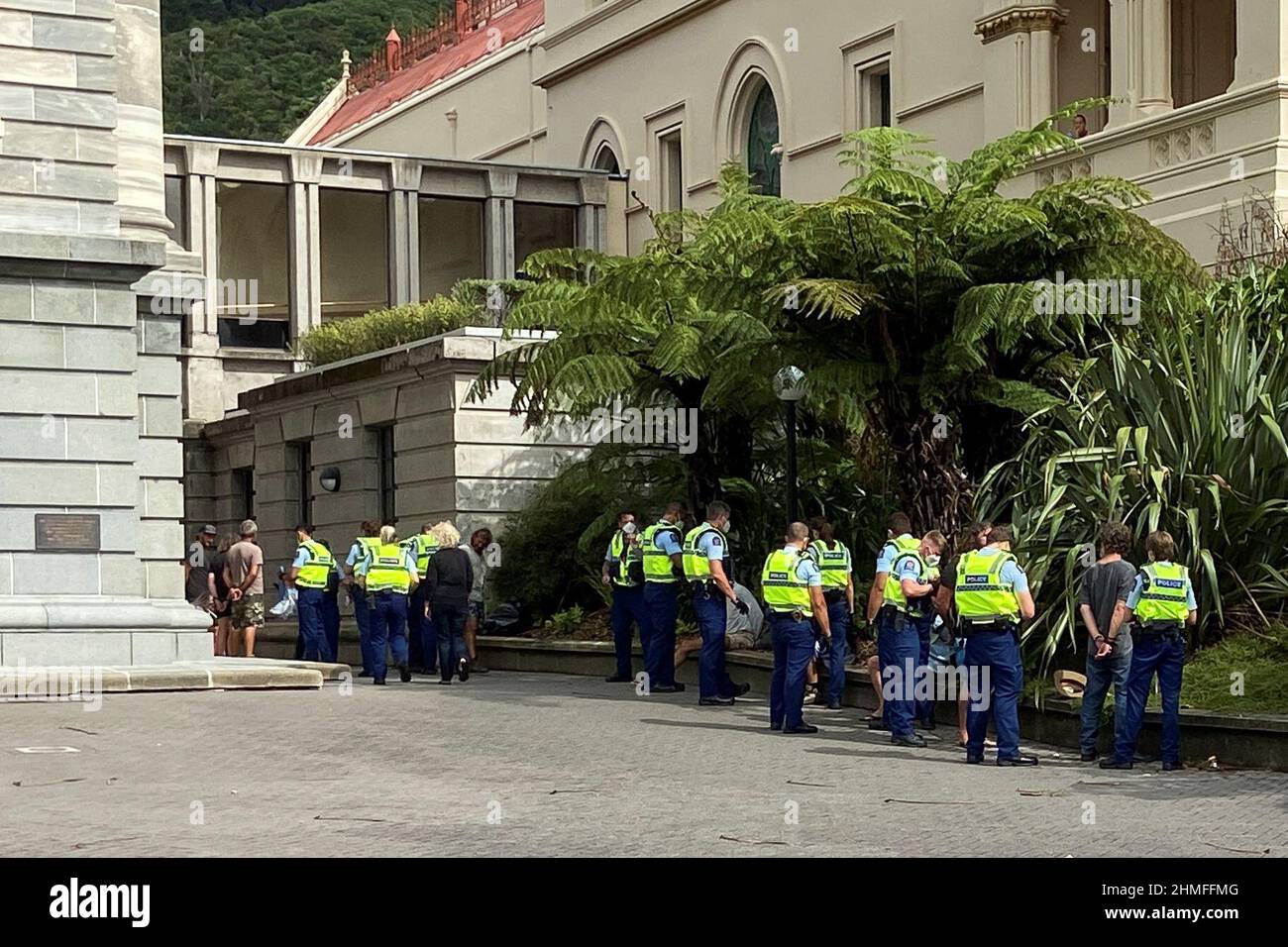 Anti-vaccine mandate protesters are detained as people gather to demonstrate in front of the parliament in Wellington, New Zealand, February 10, 2022. REUTERS/Praveen Menon Stock Photo