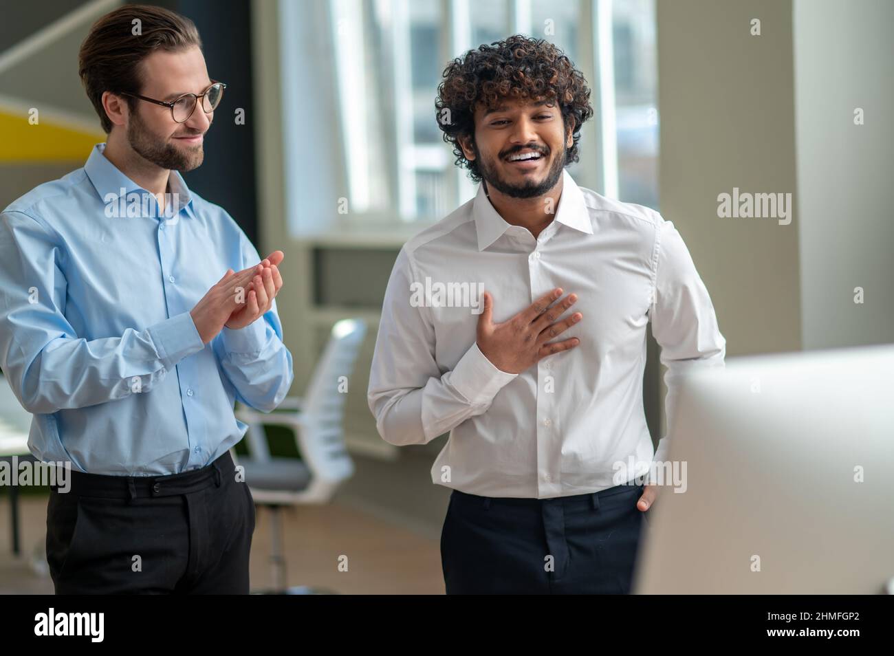 Two men standing in front of camera and looking involved Stock Photo