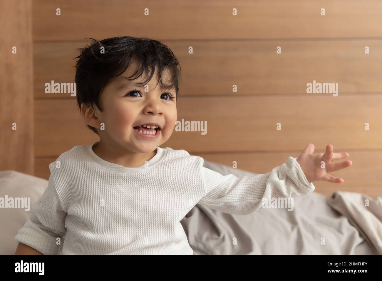 Adorable Hispanic 2 year old baby on bed after shower Stock Photo Alamy