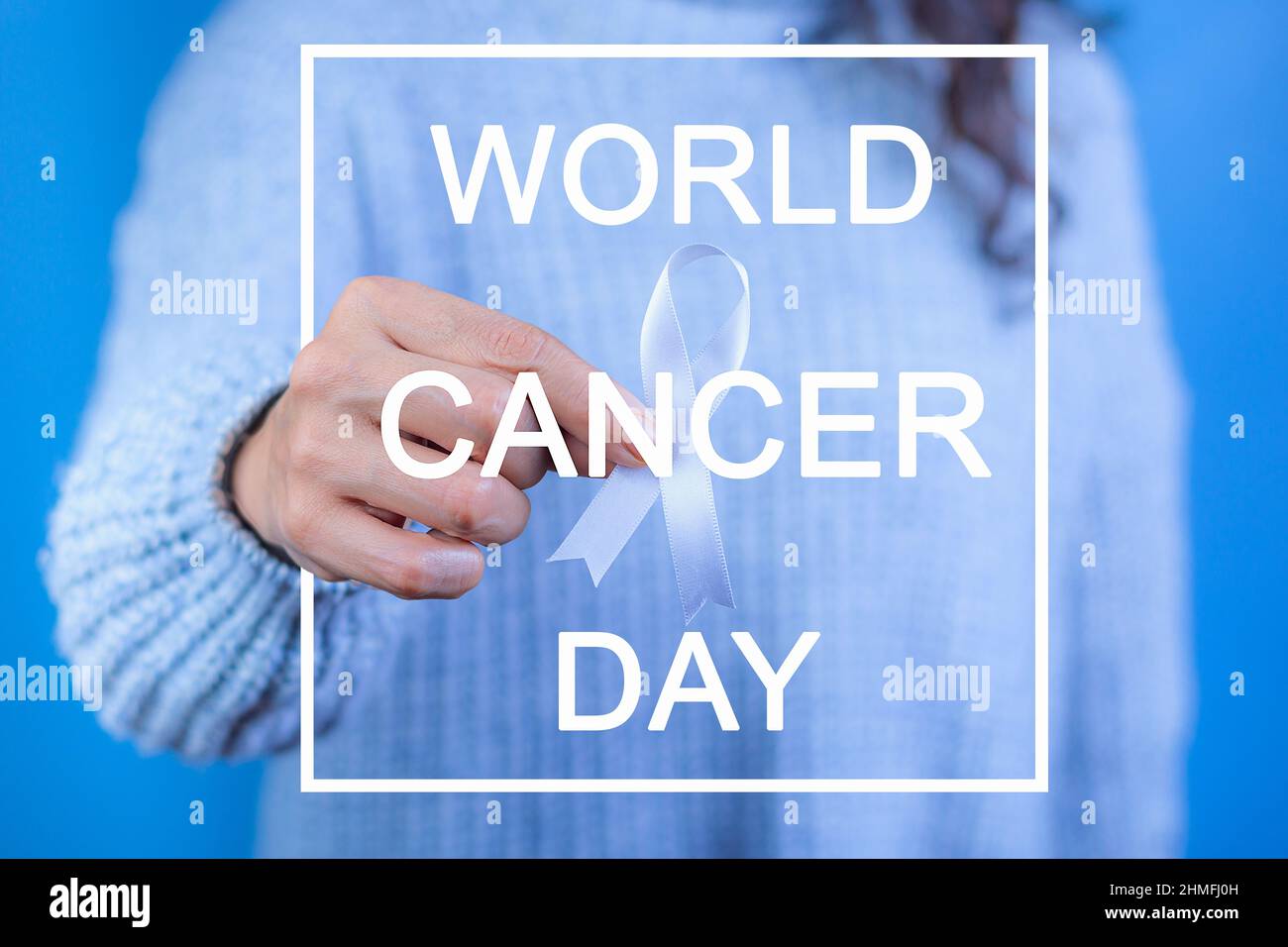 Woman with white ribbon in hand for the month of November: lung cancer awareness month, democracy and international day of peace. Health concept, Text Stock Photo