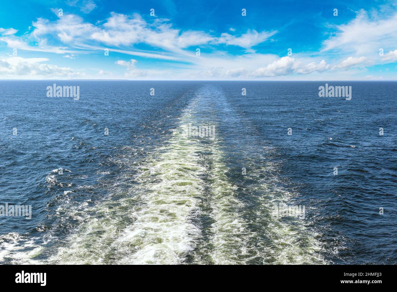 Cruise ship trails in open sea in a beautiful summer day Stock Photo