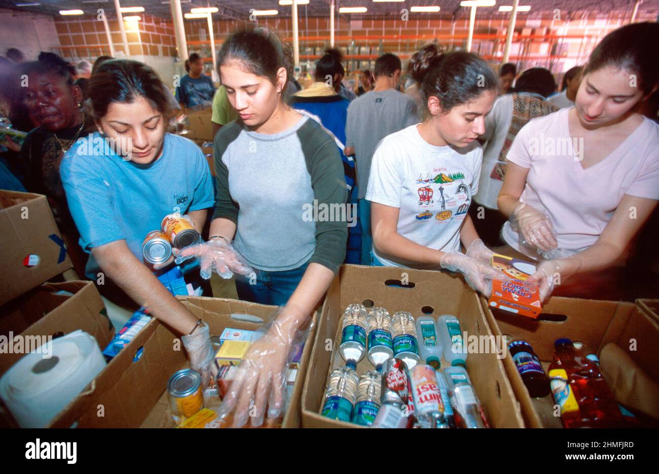 Miami Florida,Daily Bread Food Bank girls,teen teens teenagers students volunteer volunteers sorting food donations Stock Photo
