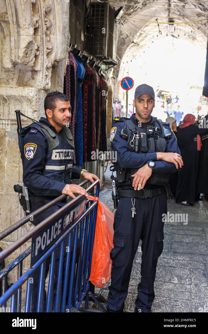 Two uniformed officers of the Israel Police provide security in the old