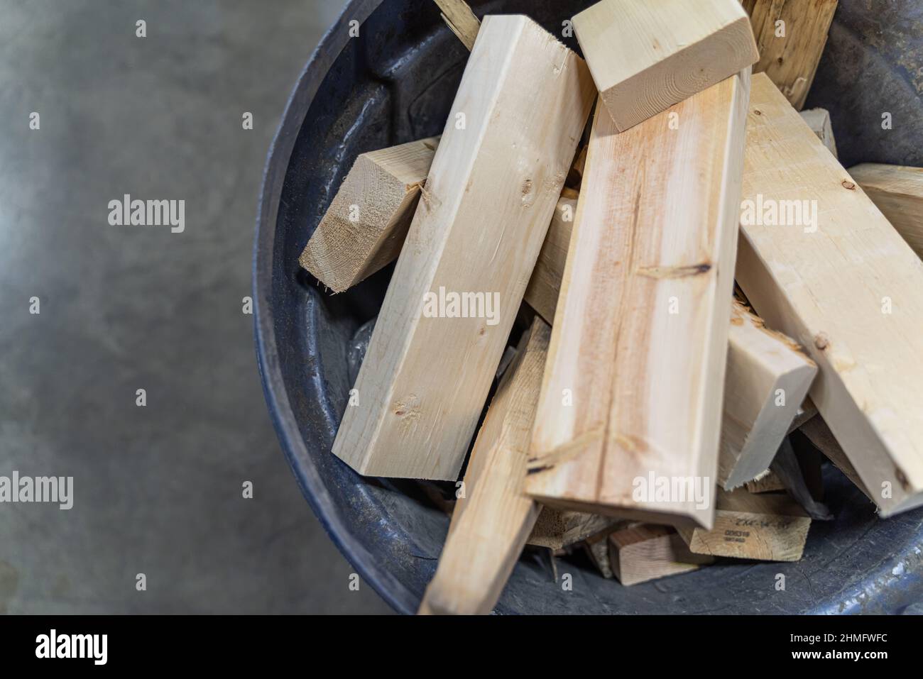 Waste pieces of wood from making crates in bin for disposal Stock Photo