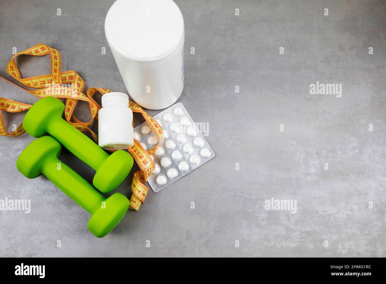 dumbbells on the background of pills. Healthy lifestyle. sports nutrition, doping Stock Photo