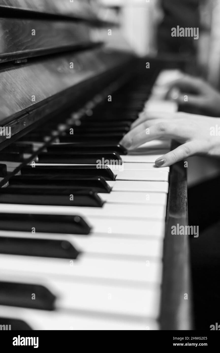 Piano keys closeup. Musical instrument in black and white photo. The hands  of a musician playing the piano are out of focus Stock Photo - Alamy
