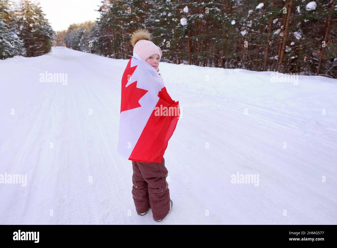 the girl is wrapped in the flag of Canada Stock Photo
