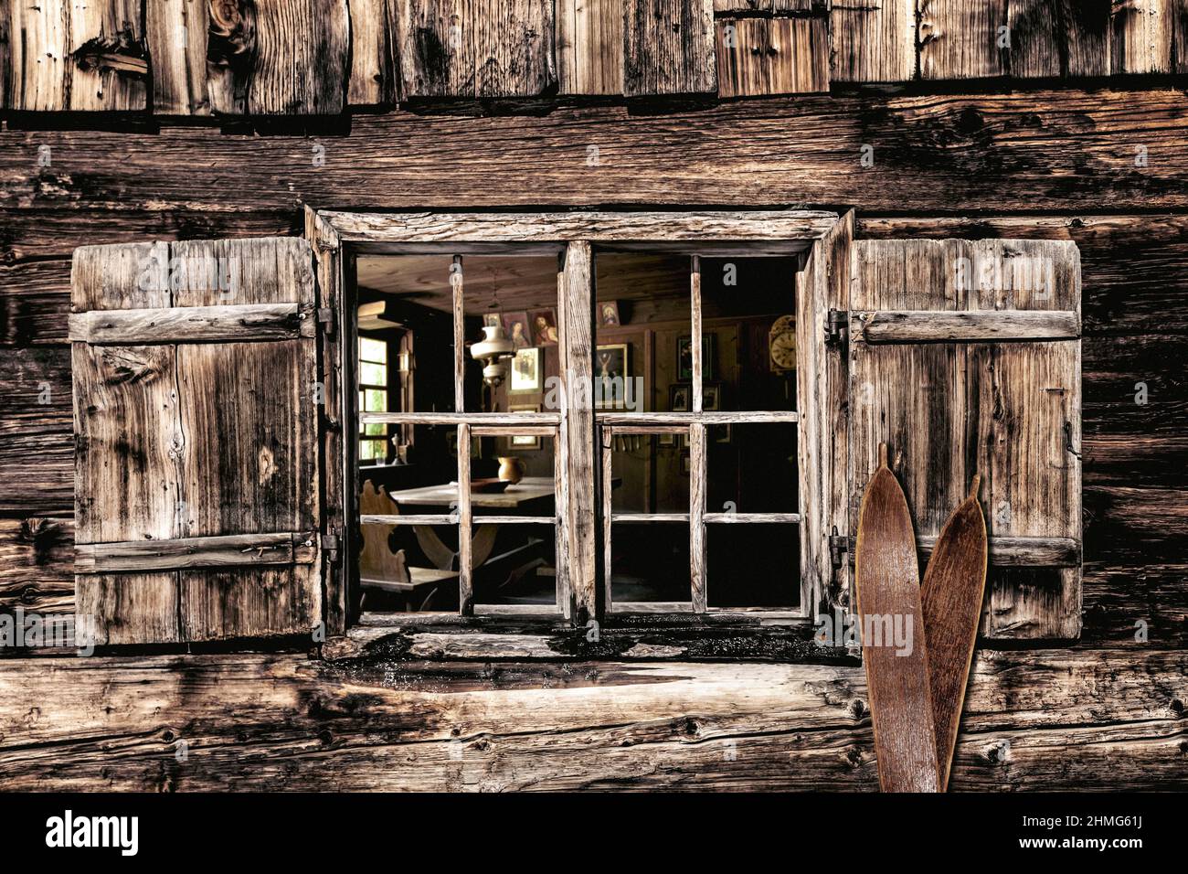 Looking through a wooden window into a rustic farmhouse parlor Stock Photo