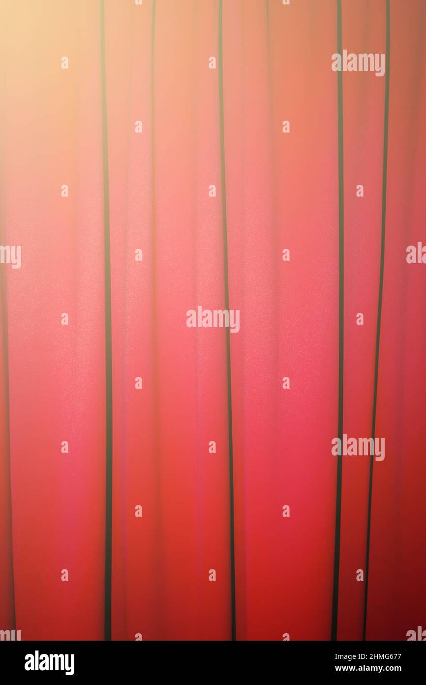 Red closed curtain with a light spot use for background Stock Photo