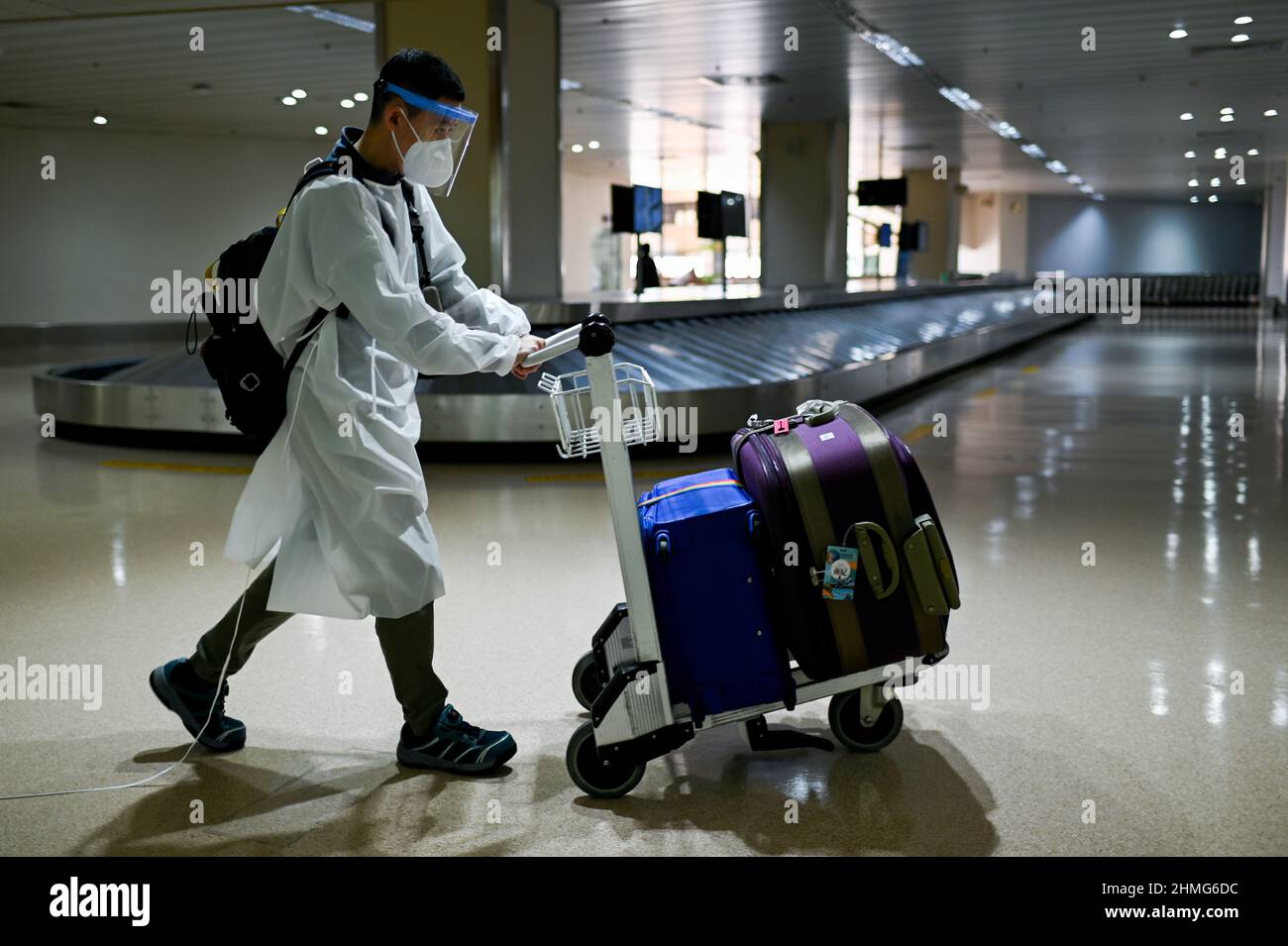 A foreign passenger wearing a face mask and a protective suit as protection  against the coronavirus disease (COVID-19) arrives at the Ninoy Aquino  International Airport, in Pasay City, Metro Manila, Philippines, February
