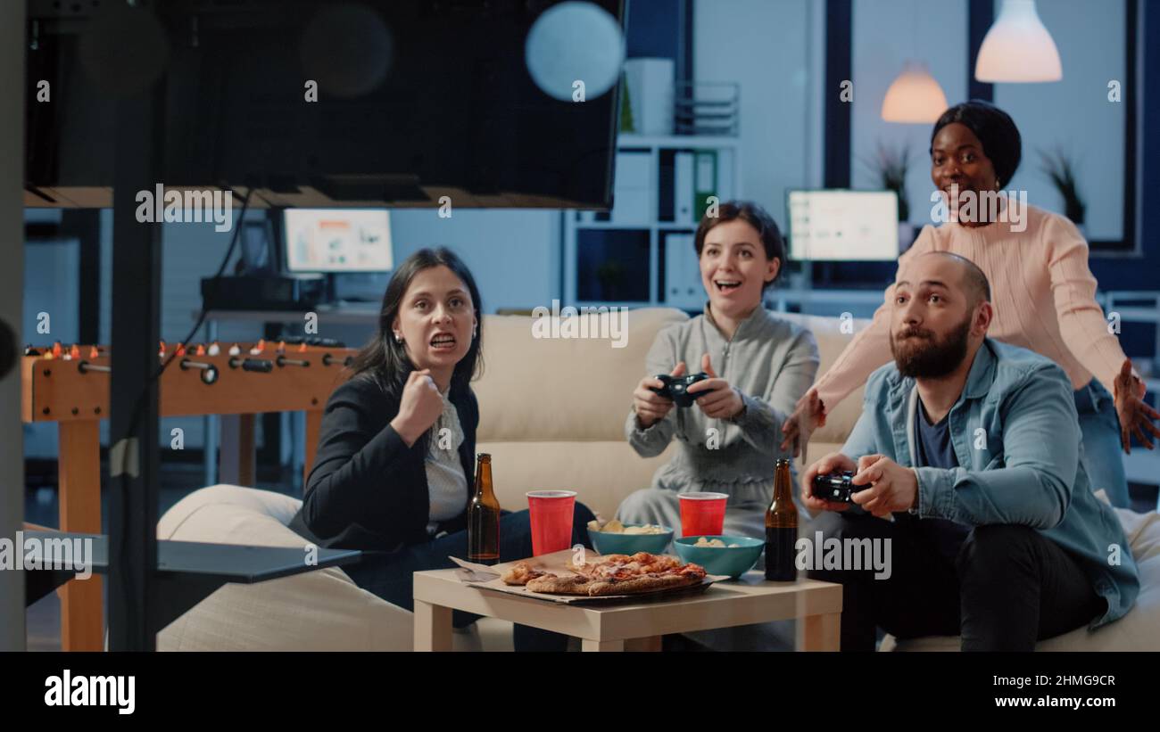 Diverse group workmates using joysticks hi-res stock photography and ...