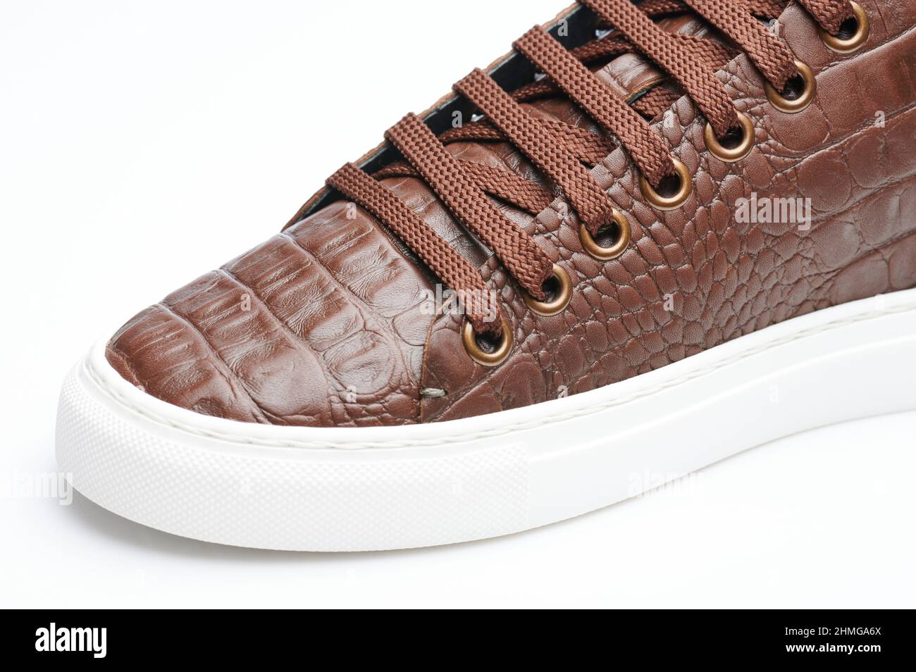 Leather snake style sneaker shoe isolated close up view Stock Photo