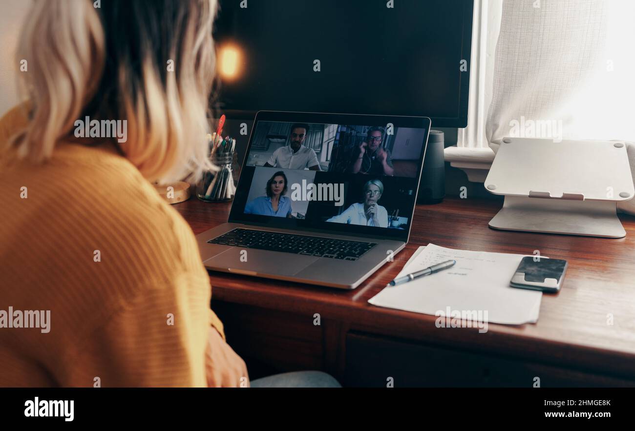 businesswoman attending a virtual meeting while working in her home office. Female entrepreneur using a laptop to video call her business partners whi Stock Photo