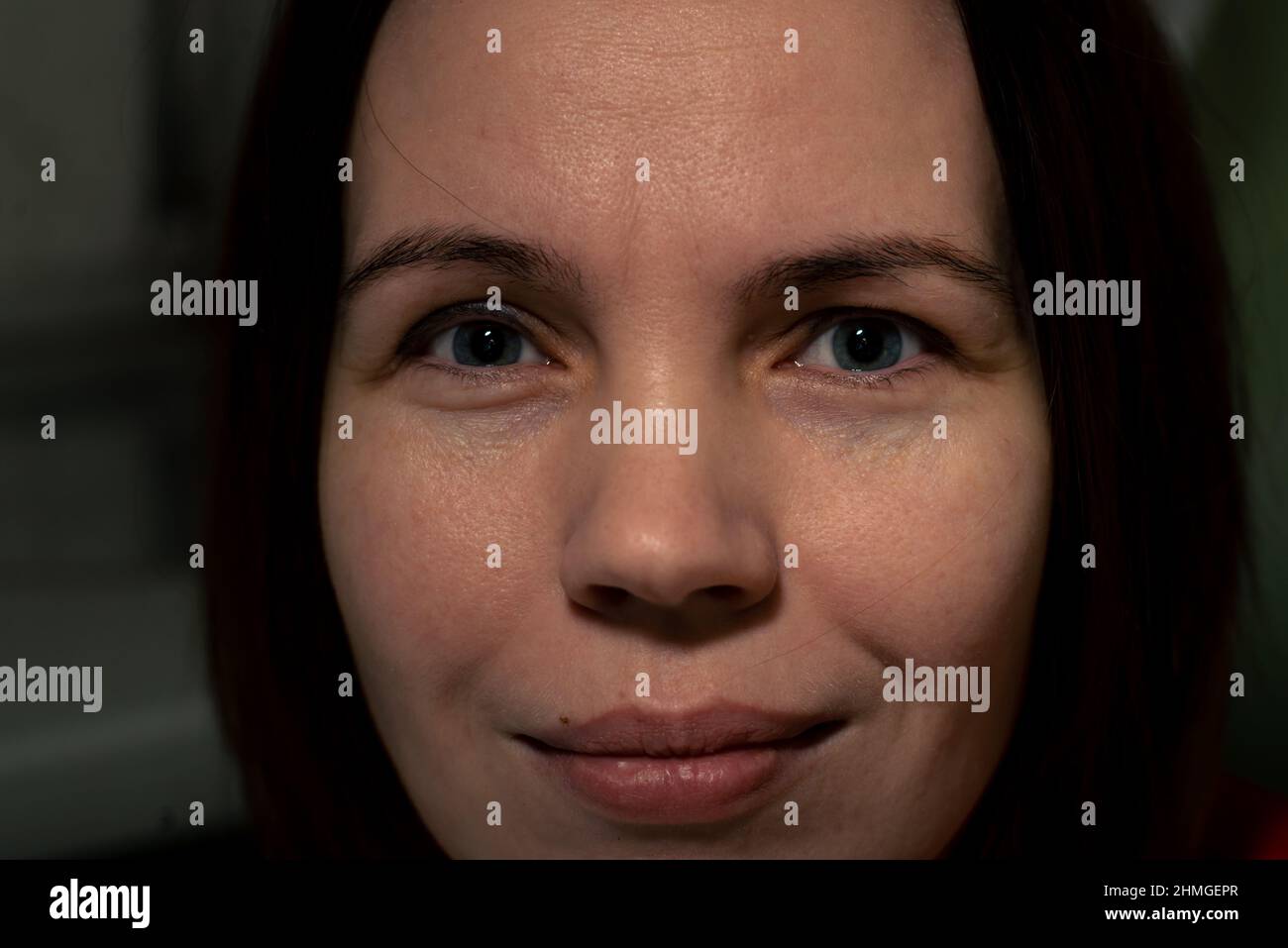 A middle-aged woman smiles. Attractive woman in her forties without make-up. Close-up. Stock Photo