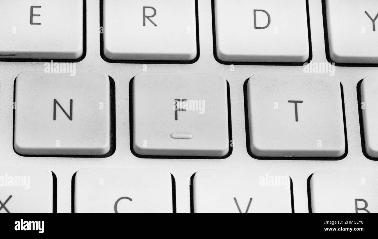 Non-fungible token or NFT concept, NFT spelled out on computer keyboard Stock Photo