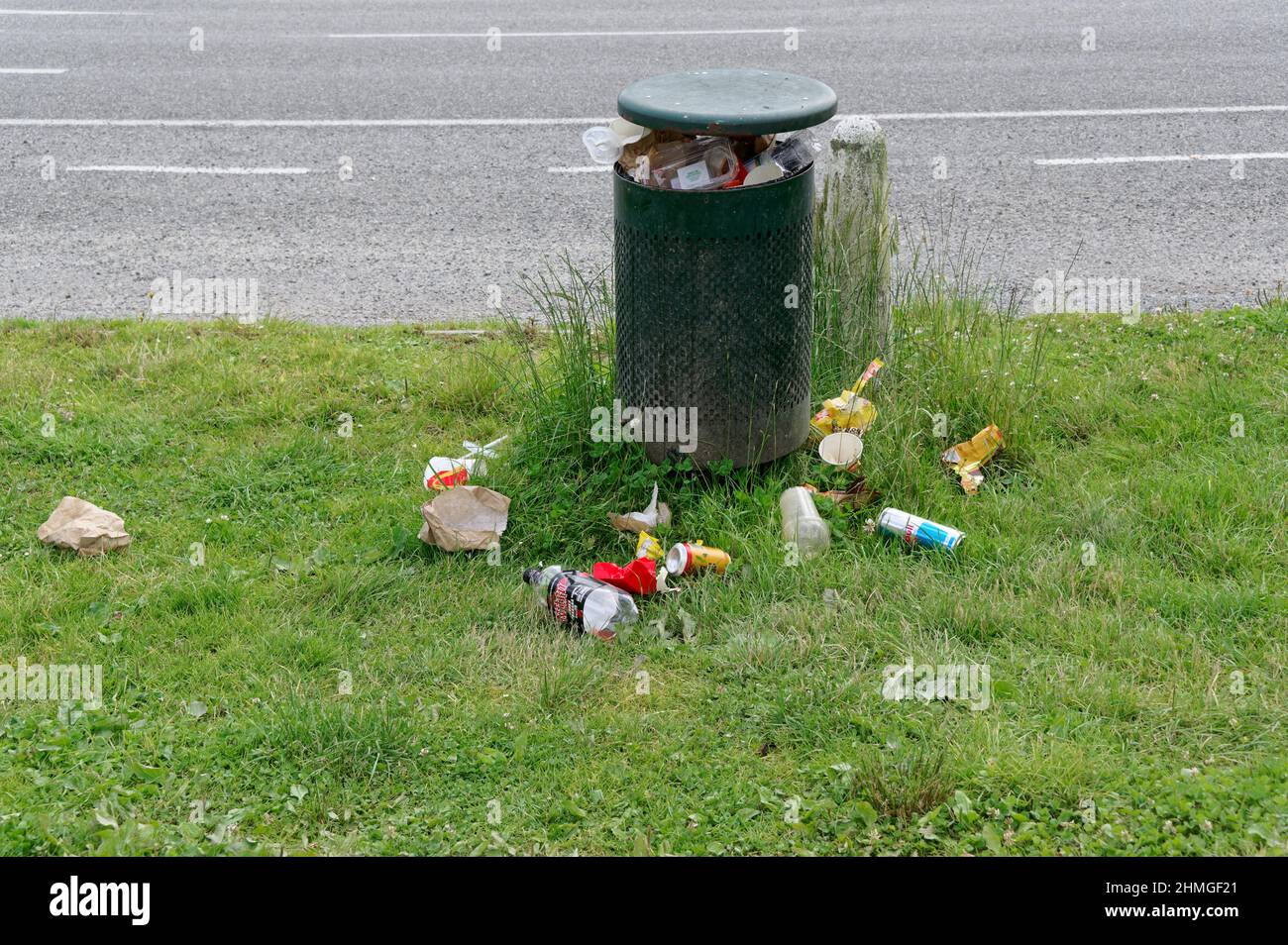 Too much rubbish has been stuffed into a rubbish bin that is now
