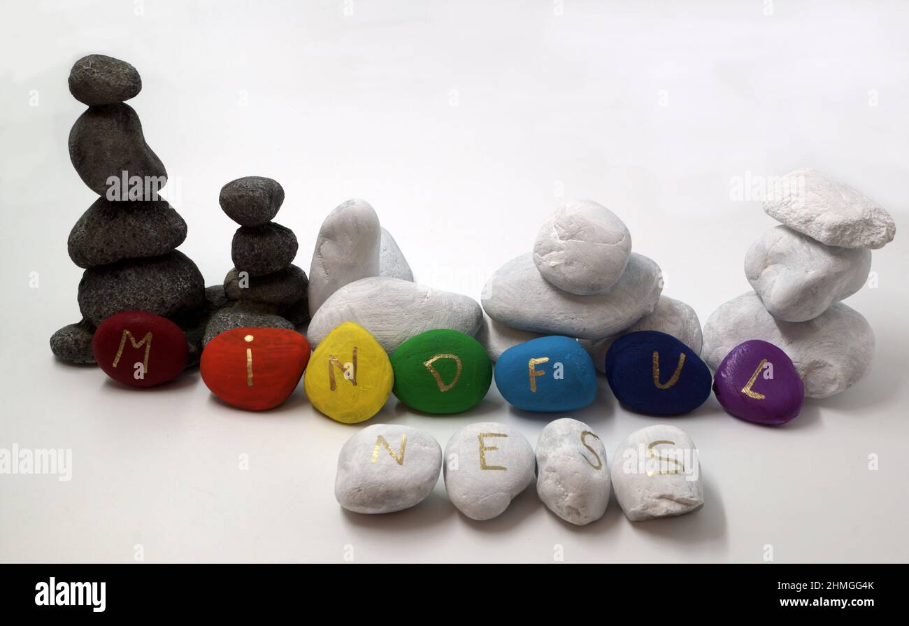 Mindfulness written on painted stones in rainbow / chakra colors. Balancing stones Stock Photo