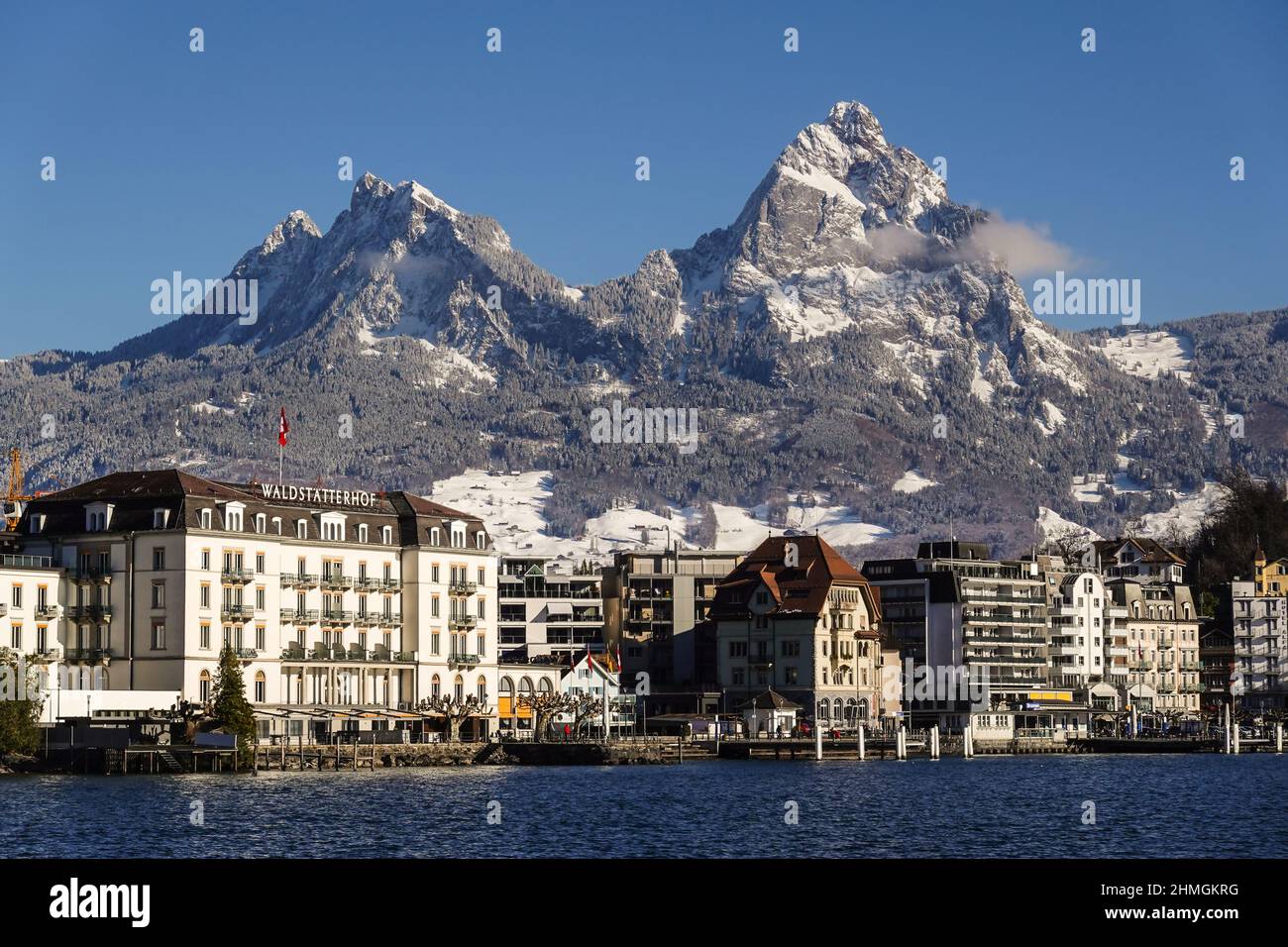 Brunnen, Switzerland - January 11 2022: Waterfront district of the Brunnen town in Canton Schwytz that lies along lake Lucerne and below the dramatic Stock Photo