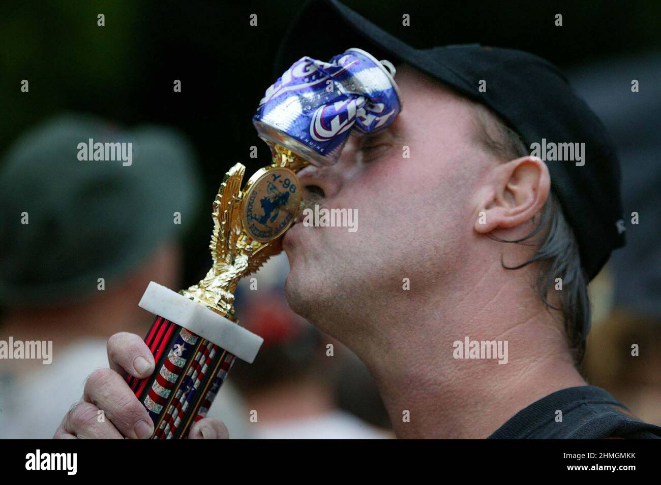 REDNECK ERIC ROBBERTSON FROM JEFFERONVILLE GOERGIA  KISSES HIS CRUSHED BEER CAN AWARD FOR WINNING THE PIG FEET DUNKING   AT THE REDNECK GAMES EAST DUBLIN GEORGIA USA. THE GAMES WERE  STARTED IN 1996 AS A RIVAL TO THE OLYMPIC GAMES HELD IN ATLANTA AND FEATURE AN UNUSUAL RANGE OF SPORTS FROM DUCKING TO PIGS FEET TO BELLY FLOPPING IN TO A MUD PIT. THE GAMES IN THERE TENTH YEAR NOW DRAW UP TO 10,000 REDNECKS FROM THE HEART OF REDNECK LAND GEORGIA STATE. PICTURES: GARYROBERTSPHOTO.COM Stock Photo