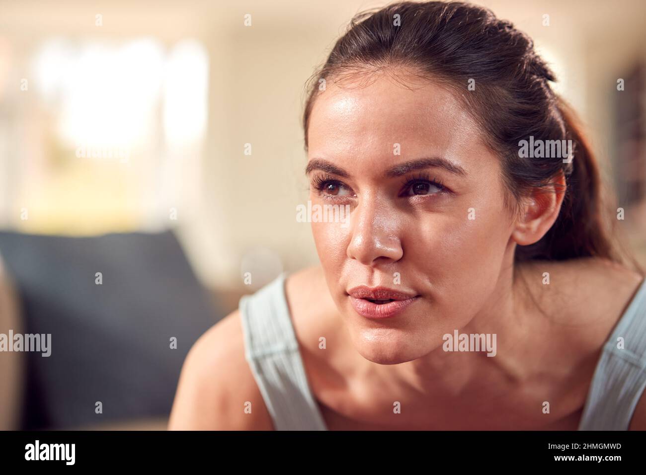 Man in Fitness Clothing at Home in Lounge Doing Press Ups and