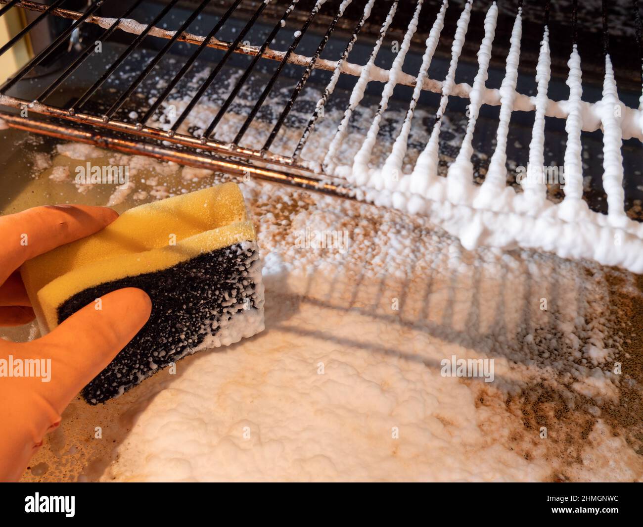 Cleaning an oven with spray and sponge Stock Photo Alamy